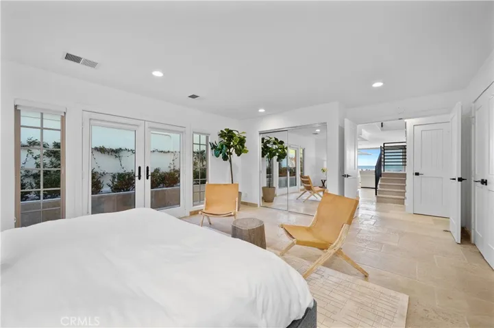 Main floor bedroom with separate french door entrance