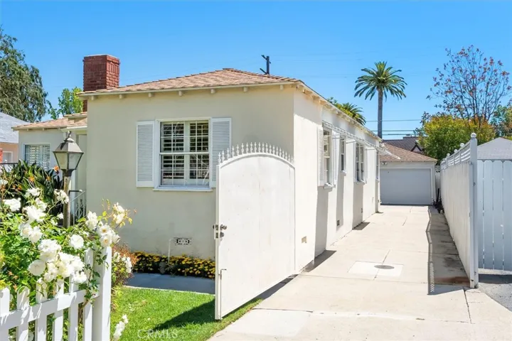 Long driveway leads to detached garage.