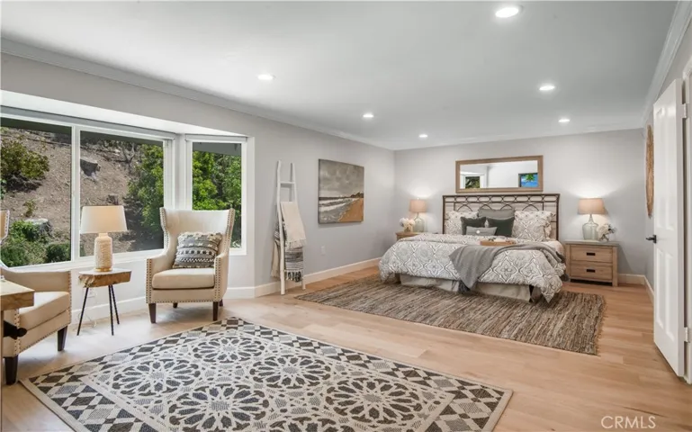 Luxuriously large primary suite with view to backyard.
