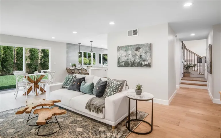 Great room with dining area open to breakfast bar and kitchen.