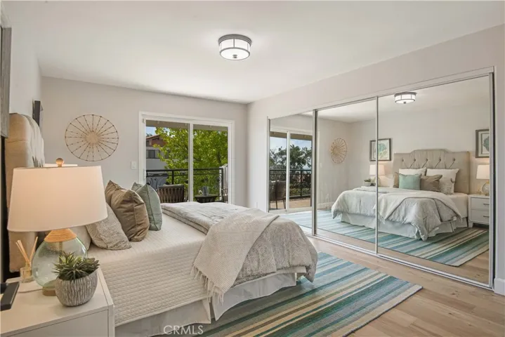 Three mirrored closet doors, this bedroom also has direct access to the balcony.