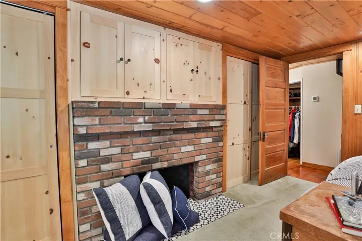 Primary bedroom.  Please note lower fireplace is not functional.