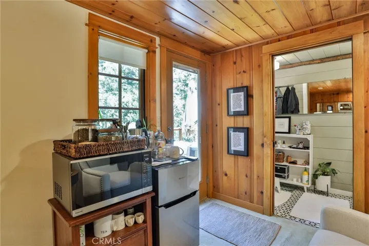 Primary bedroom and view into bathroom and outside deck access.