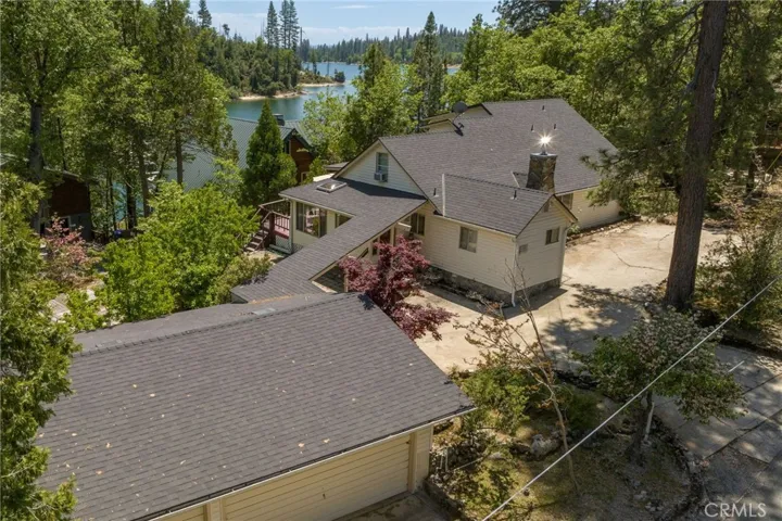 aerial view of home garage and lakeview