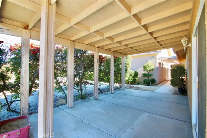 Covered patio leading to second garage