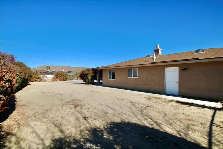 Large side yard next to house, fully fenced