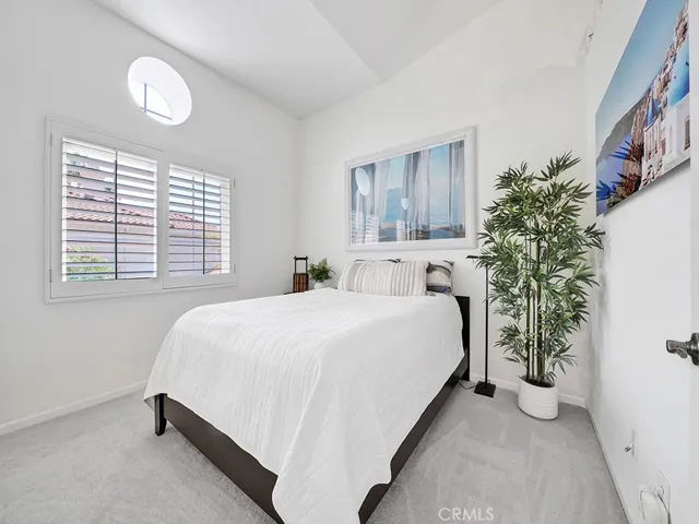 The upstairs guest bedroom has a spacious closet and vaulted ceilings.