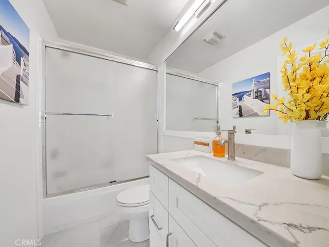 The upstairs hallway bathroom has remodeled floors and a remodeled vanity.