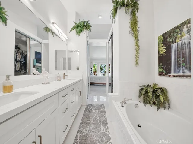 The primary bathroom also has dual mirrored closets.