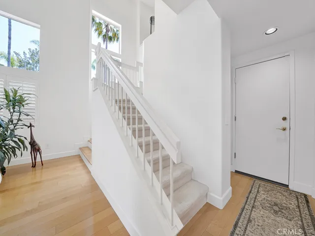 Hallway leading to the garage, downstairs half bath plus a storage closet.
