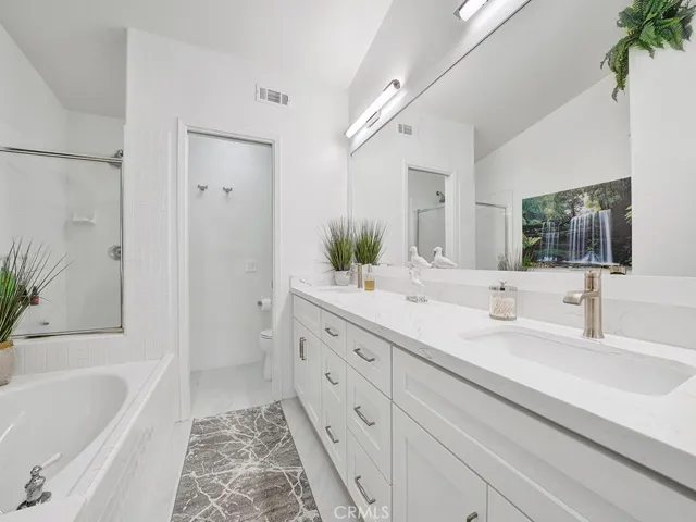The primary bathroom is also remodeled with dual sinks with a quartz countertop.