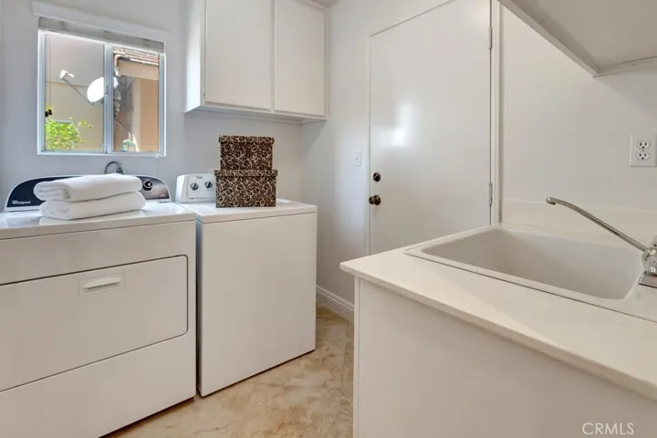 Inside Laundry Room with Sink and Direct Garage Access