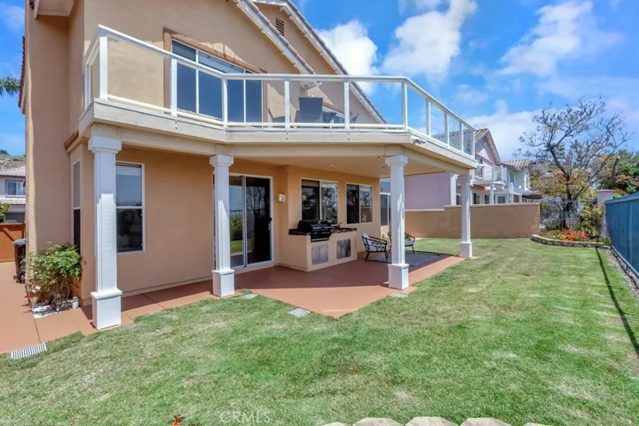Backyard Showing Upper & Lower Patios with Built-In BBQ & Sink
