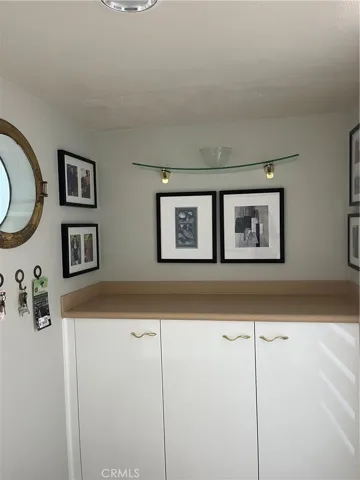 Additional storage added and view of front door from kitchen
