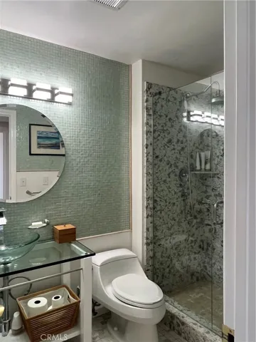 Hall bathroom offers easy walk in shower access
