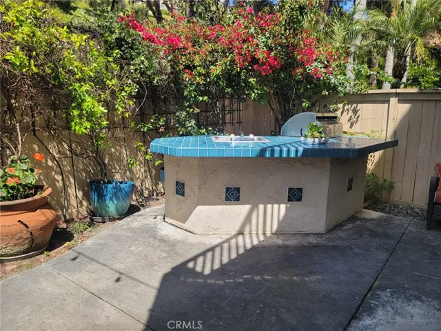 Outdoor BBQ bar with sink and 1 year old grill