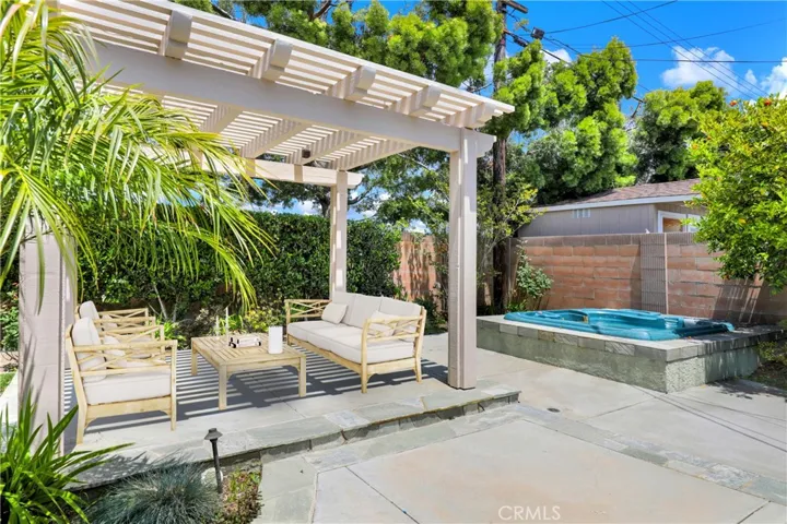 Backyard with a lattice cover with lights.  Area Virtually Staged
