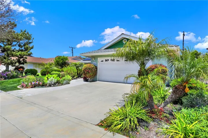 Two car garage surrounded by lovely landscaping