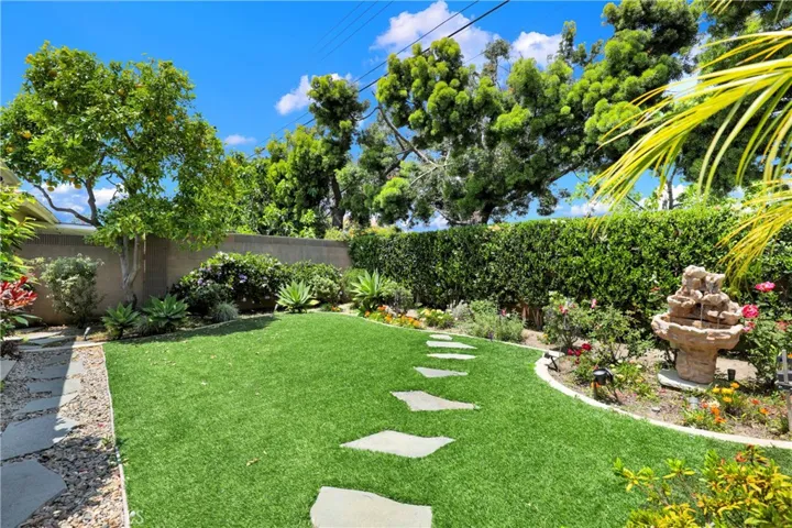 Landscaped backyard with a soothing​​‌​​​​‌​​‌‌​​‌​​​‌‌​​​‌​​‌‌​​‌‌​​‌‌​​​​ fourntain
