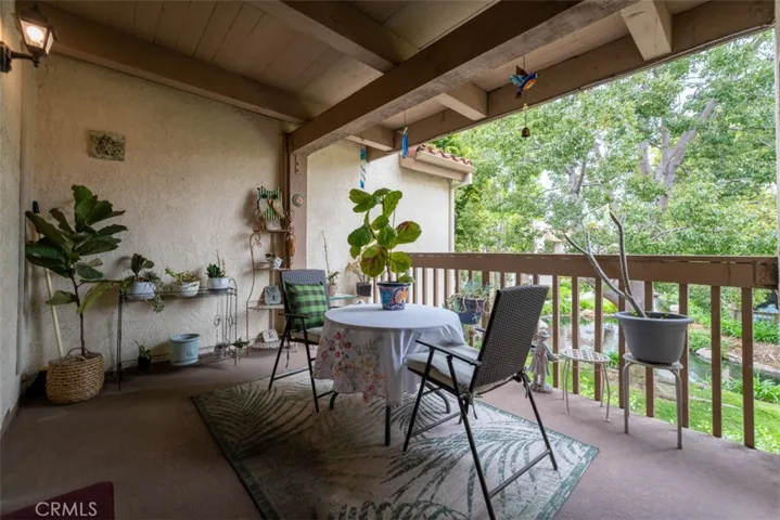 The balcony looks out onto mature trees, grass and a running stream. So peaceful!