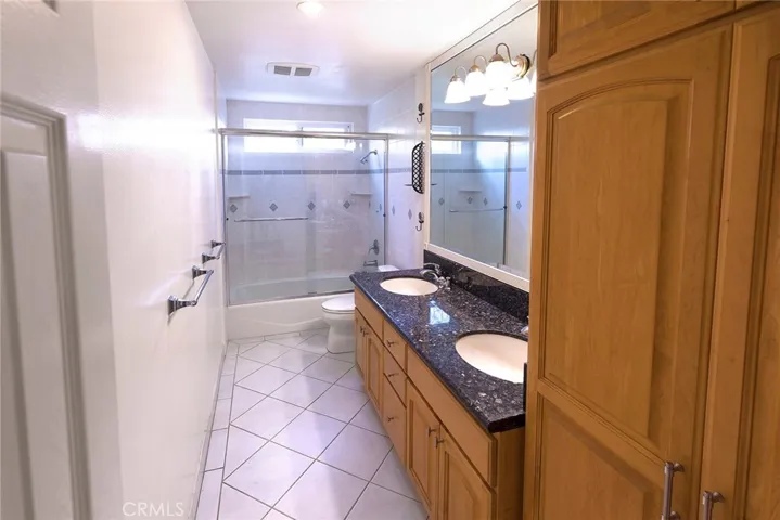 Full Bath with double sinks between two large oversized bedrooms