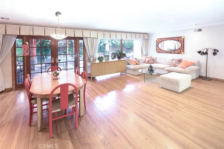 Another view of Living Room from Dining Area overlooking backyard with stone patio and pergola