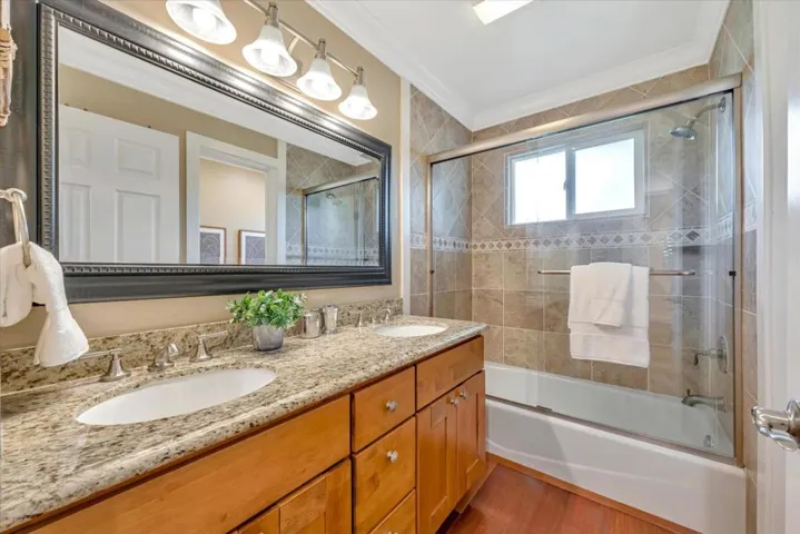 Guest bath has two sinks and a separate commode area.