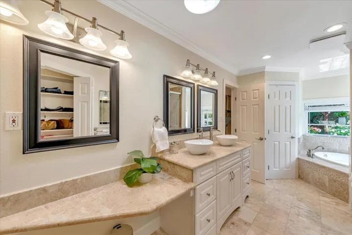 Primary bath with large shower, separate commode area, luxurious tub and make-up vanity.