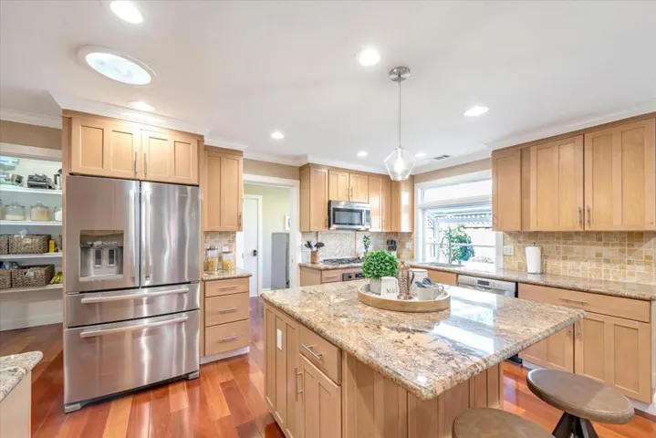 Open kitchen with new lighting and the perfect layout for easy living.