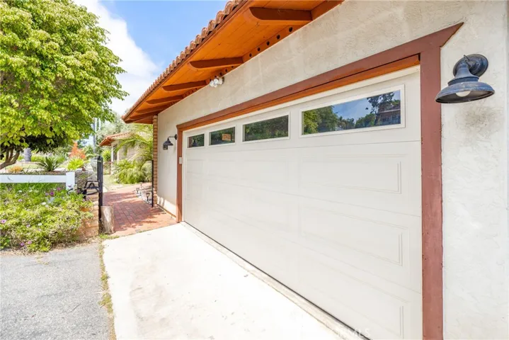 Garage door with access to front door, through a security gate