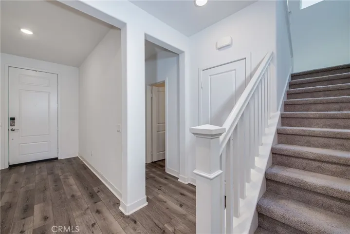 Downstairs next to the front entrance is Bedroom 2 and a full bathroom.