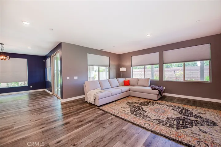 The spacious living room is in the back of the home and is highlighted by the multiple windows.