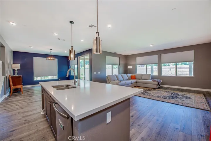 The kitchen island is home to the sink and dishwasher. Notice the multiple windows that keep the space light and bright.