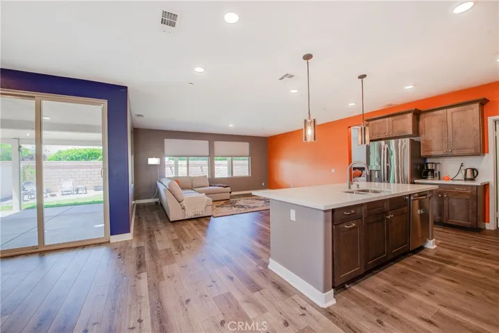 This open concept floor plan is ideal with the kitchen looking into the dining and living rooms. There are multiple large windows to let the natural light flow throughout the space.