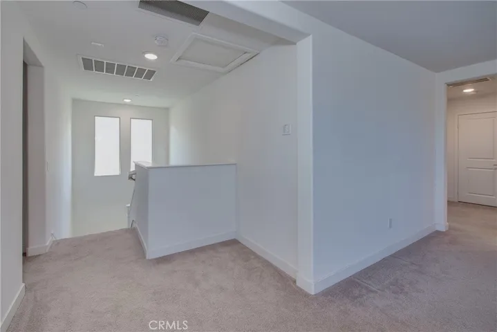 One of the whole house fans is located at the top of the stairs.