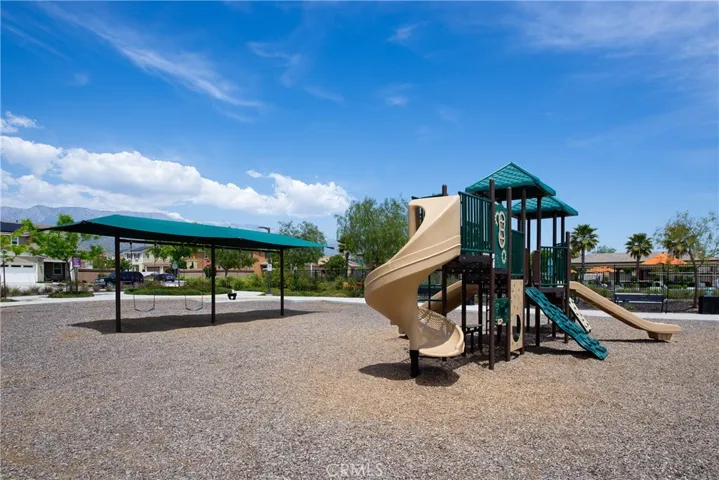 The playground has swings and a play area with slides, climbers, etc.