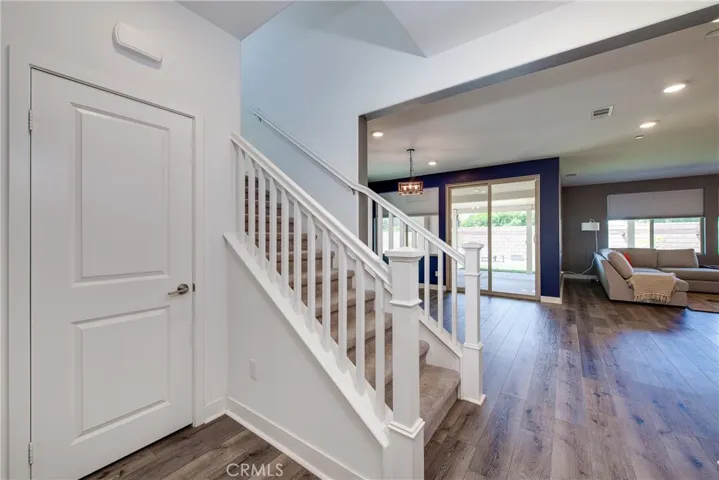 The laminate flooring, high baseborards and recessed lighting is continued throughout most of the downstairs.