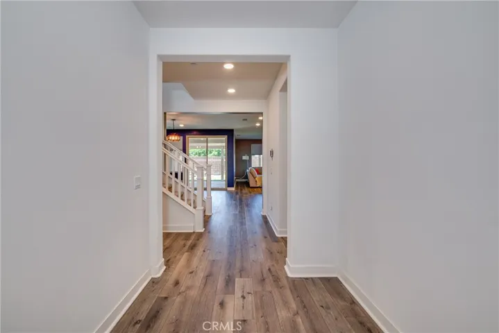 The wide foyer welcomes you into the home along with laminate flooring, high baseboards and recessed lighting.