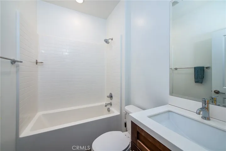 The downstairs full bathroom is next to Bedroom 2 and has a shower/bathtub combination.
