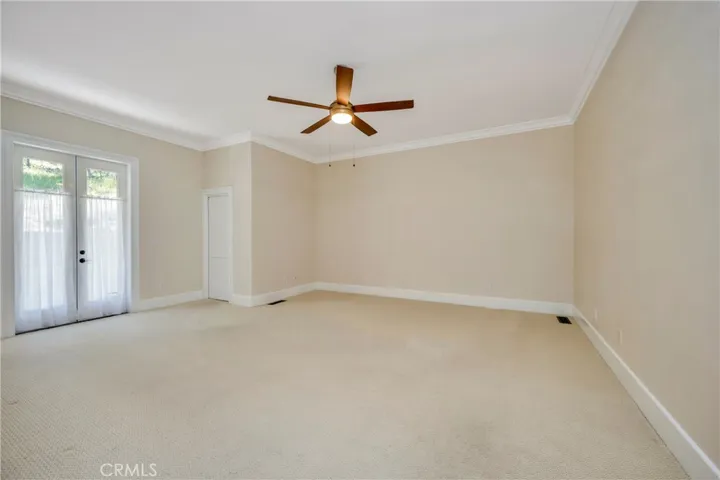Primary with walk closet with built ins & French doors to back patio