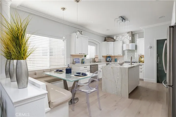 Chefs kitchen featuring custom built-in eating area