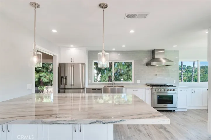 Completely remodeled kitchen features center island with quartzite counter, stainless Dacor appliances, gorgeous view!