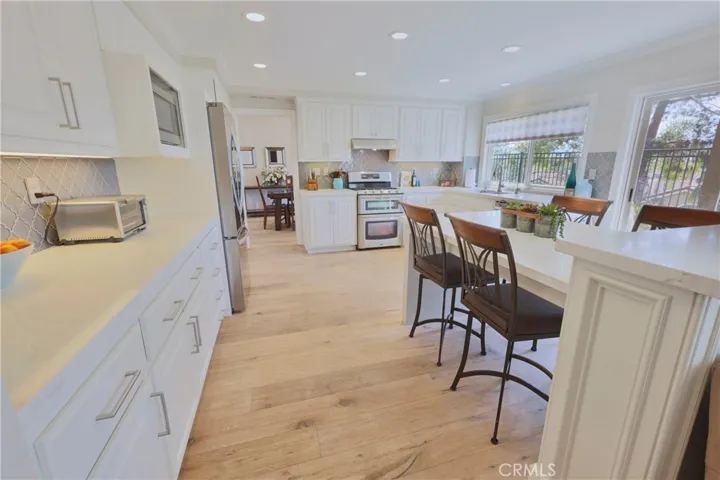 Remodeled kitchen with quartz counters and updated backsplash.