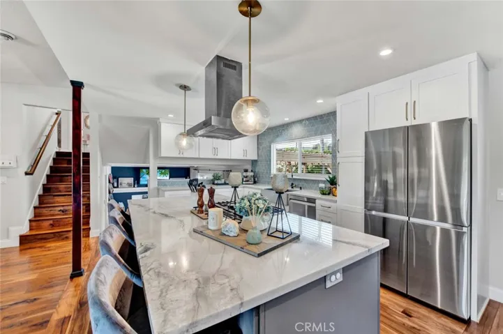 The "Open" Kitchen features a Huge Center Island w/Seating & Pendant Lights, Quartz Countertops
