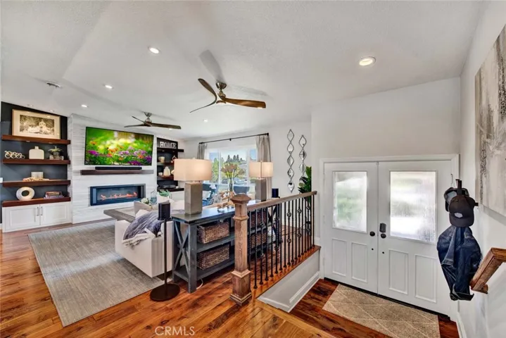 Smooth Ceilings, and a Chic Marble Fireplace w/Mantel, flanked by Custom Built-Ins & Floating Shelving