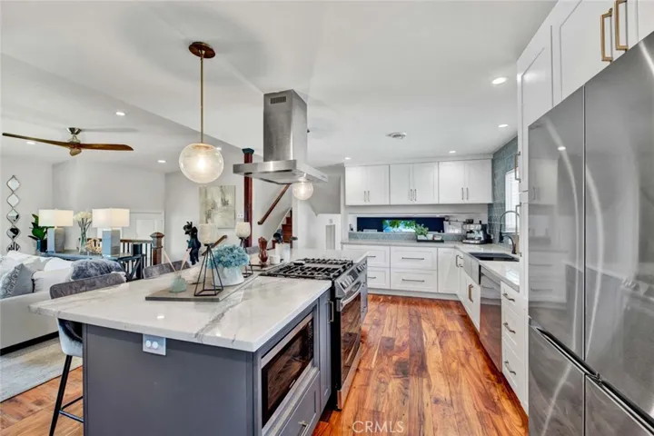 Open" Kitchen features a Huge Center Island w/Seating & Pendant Lights, Quartz Countertops