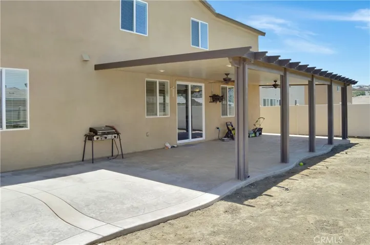 What a great backyard with an expansive stamped concrete patio partially covered by an AlumaWood cover with fans and recessed lighting and a nearly blank slate to landscape to your taste. Yes, this is a premium, pool-sized lot!