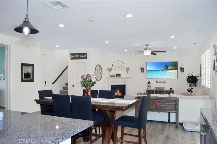 The dining area is perfectly located between the living area and the kitchen and offers access to the covered patio, backyard views, recessed lighting, and more of that luxury waterproof flooring