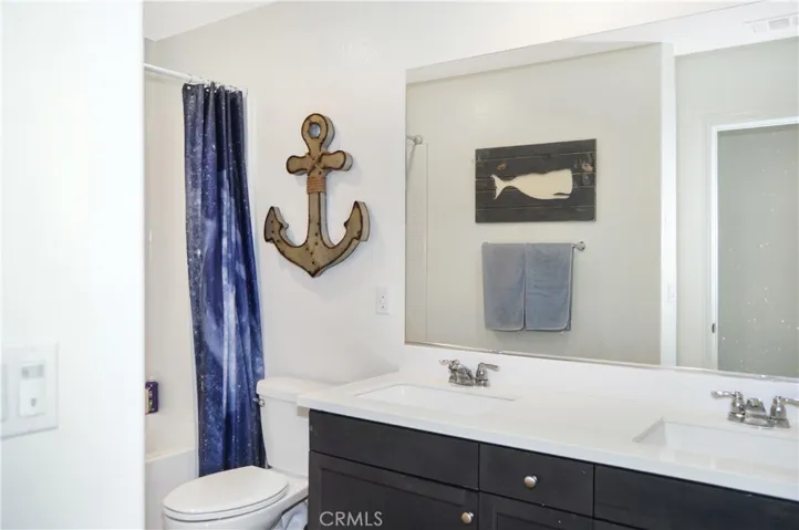 The 2nd bath is next to Bedroom #2 and has dual sinks, a tub/shower combo, and more luxury vinyl plank flooring