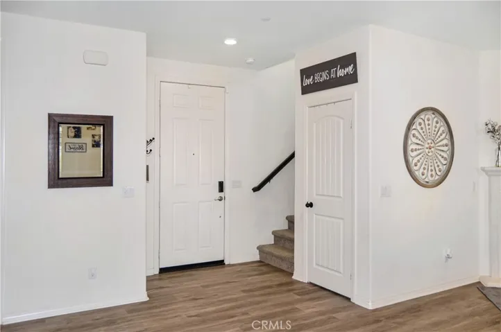 Entry is adjacent to the closet under the stairs with space for coats and much more